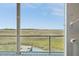 Expansive marsh views from this property's enclosed porch with white-painted wood flooring and silver railings at 1676 E Ashley Ave, Folly Beach, SC 29439