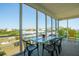 A screened-in porch provides scenic views of the community and outdoor dining at 1676 E Ashley Ave, Folly Beach, SC 29439