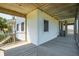 Corner view of a home's expansive outdoor porch with weathered decking and white siding at 1676 E Ashley Ave, Folly Beach, SC 29439