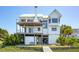 Beautiful multi-level home with balconies, large windows, and private dock access to the waterway at 1676 E Ashley Ave, Folly Beach, SC 29439
