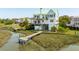Stunning waterfront home featuring a private dock, multiple decks, and lush landscaping at 1676 E Ashley Ave, Folly Beach, SC 29439