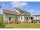 Spacious backyard with green lawn, manicured landscaping, and an outdoor kitchen area perfect for entertaining at 1755 Bolden Dr, Mount Pleasant, SC 29466