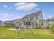 Expansive backyard with a playset, lush lawn, and a patio area, perfect for outdoor activities and gatherings at 1755 Bolden Dr, Mount Pleasant, SC 29466