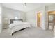 Cozy bedroom featuring neutral carpeting, ceiling fan, and a doorway leading to a bathroom at 1755 Bolden Dr, Mount Pleasant, SC 29466