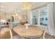 Bright dining area with a wooden table, stylish chandelier, and large windows with backyard view at 1755 Bolden Dr, Mount Pleasant, SC 29466