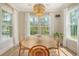 Dining area with a wooden table, stylish chandelier, and windows with nature views at 1755 Bolden Dr, Mount Pleasant, SC 29466