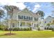 Charming two-story home with a welcoming front porch and well-manicured lawn at 1755 Bolden Dr, Mount Pleasant, SC 29466