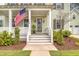 Charming home with a welcoming front porch, American flag, and well-maintained landscaping at 1755 Bolden Dr, Mount Pleasant, SC 29466