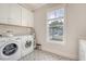 Bright laundry room with modern appliances, ample counter space, and a patterned tile floor at 1755 Bolden Dr, Mount Pleasant, SC 29466
