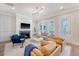 Elegant living room with a cozy fireplace, stylish decor, and ample natural light streaming through large windows at 1755 Bolden Dr, Mount Pleasant, SC 29466