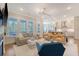 Bright, open-concept living room with modern furnishings and hardwood floors flowing into a stunning kitchen at 1755 Bolden Dr, Mount Pleasant, SC 29466