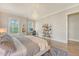 Tranquil main bedroom with a chandelier, a large window, and a dedicated workspace, perfect for relaxation at 1755 Bolden Dr, Mount Pleasant, SC 29466