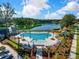 Aerial view of a community pool and amenity center, surrounded by lush landscaping and a tranquil lake at 1755 Bolden Dr, Mount Pleasant, SC 29466
