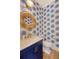Stylish powder room with unique wallpaper, a chic mirror, and elegant fixtures and finishes at 1755 Bolden Dr, Mount Pleasant, SC 29466