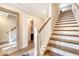 Elegant staircase featuring wood steps, white risers, and a decorative mirror on the landing at 1755 Bolden Dr, Mount Pleasant, SC 29466