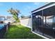A fenced backyard features green grass, partial pool view, and screened-in porch, creating a relaxing outdoor space at 1907 Mossdale Dr, Johns Island, SC 29455
