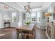 Bright dining room with a farmhouse-style table, updated lighting, and fresh décor at 1907 Mossdale Dr, Johns Island, SC 29455