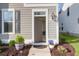 Inviting entryway with stylish decor, plants, and a freshly painted front door with house number at 1907 Mossdale Dr, Johns Island, SC 29455