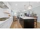Bright kitchen with white cabinets, stainless steel appliances, and an island with pendant lighting at 1907 Mossdale Dr, Johns Island, SC 29455