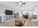 Open-concept living space with hardwood floors, stylish furniture, and kitchen view at 1907 Mossdale Dr, Johns Island, SC 29455