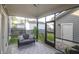 Cozy screened-in patio with a comfortable sofa and a view of the backyard at 1907 Mossdale Dr, Johns Island, SC 29455
