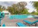 A refreshing community pool with turquoise lounge chairs and umbrellas at 1907 Mossdale Dr, Johns Island, SC 29455