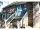 Brick exterior with steps leading to a glass door entrance, framed by white railings at 20 Anderson Ave, Charleston, SC 29412
