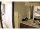 Bathroom features a vanity and a shower/tub combo, with light streaming in from a window with shutters at 20 Anderson Ave, Charleston, SC 29412