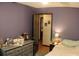 Comfortable bedroom with a queen-sized bed, a small dresser, and decor that adds to the room's charm at 20 Anderson Ave, Charleston, SC 29412
