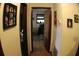 Long hallway with wood-look flooring and natural light peeking in from a room at the end at 20 Anderson Ave, Charleston, SC 29412