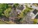 Aerial view of a home's backyard featuring mature trees, lake access, and wooden fence at 2007 Robin Wood Blvd, Moncks Corner, SC 29461