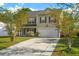 Charming two-story home featuring a manicured lawn, a driveway, and an attached two-car garage at 2007 Robin Wood Blvd, Moncks Corner, SC 29461