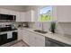 Well-lit kitchen boasts white cabinets, stainless steel appliances, and granite countertops at 202 Resinwood Rd, Moncks Corner, SC 29461