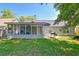 View of a back exterior that includes a screened porch, grill and backyard at 208 Evesham Dr, Summerville, SC 29485