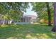 A lovely backyard features a screened in porch and well-manicured lawn at 208 Evesham Dr, Summerville, SC 29485