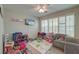Spacious playroom filled with toys, a comfortable seating area, and natural light at 208 Evesham Dr, Summerville, SC 29485