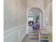 Inviting hallway with wood floors and decorative archway leading to the living spaces at 208 Evesham Dr, Summerville, SC 29485