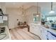 Bright kitchen area features white cabinets, stainless steel appliances, and an adjacent dining area at 208 Evesham Dr, Summerville, SC 29485