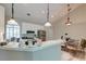 Kitchen bar with pendant lights, white cabinets, and stainless steel appliances at 208 Evesham Dr, Summerville, SC 29485