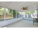 Enclosed back porch with ceiling fan, offering a serene view of the backyard at 208 Evesham Dr, Summerville, SC 29485