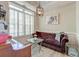 Inviting sitting room with a stylish chandelier, large window with shutters, and comfortable plum colored couch at 208 Evesham Dr, Summerville, SC 29485