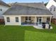Spacious backyard with screened-in porch, a grill, and lush green grass, perfect for outdoor living at 218 Wexford Ct, Summerville, SC 29483