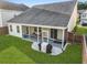 Spacious backyard with screened-in porch, a grill, and lush green grass, perfect for outdoor living at 218 Wexford Ct, Summerville, SC 29483