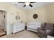 Cozy Bedroom featuring a crib, rocking chair, dresser, and carpet flooring at 218 Wexford Ct, Summerville, SC 29483
