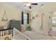 Bright bedroom featuring plush carpet, a crib, and a window with dinosaur themed decor at 218 Wexford Ct, Summerville, SC 29483