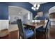 Elegant dining room with wainscoting and an open view to a living room with comfy furniture at 218 Wexford Ct, Summerville, SC 29483