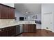 Open kitchen with stainless steel appliances, granite countertops, and dark wood cabinetry at 218 Wexford Ct, Summerville, SC 29483