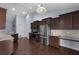 Well-lit kitchen showcasing stainless appliances, ample counter space, and modern dark wood cabinets at 218 Wexford Ct, Summerville, SC 29483