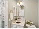 Powder room with designer mirror, tasteful sconces, and white marble countertop. Designer touches throughout at 22 Sheppard St, Charleston, SC 29403