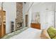 Bedroom with a four-poster bed, brick fireplace, hardwood floors, and built-in cabinets at 22 Sheppard St, Charleston, SC 29403